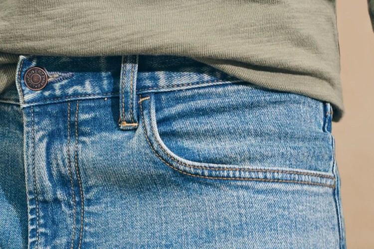 a close up of a model in Faherty's Organic Cotton Denim