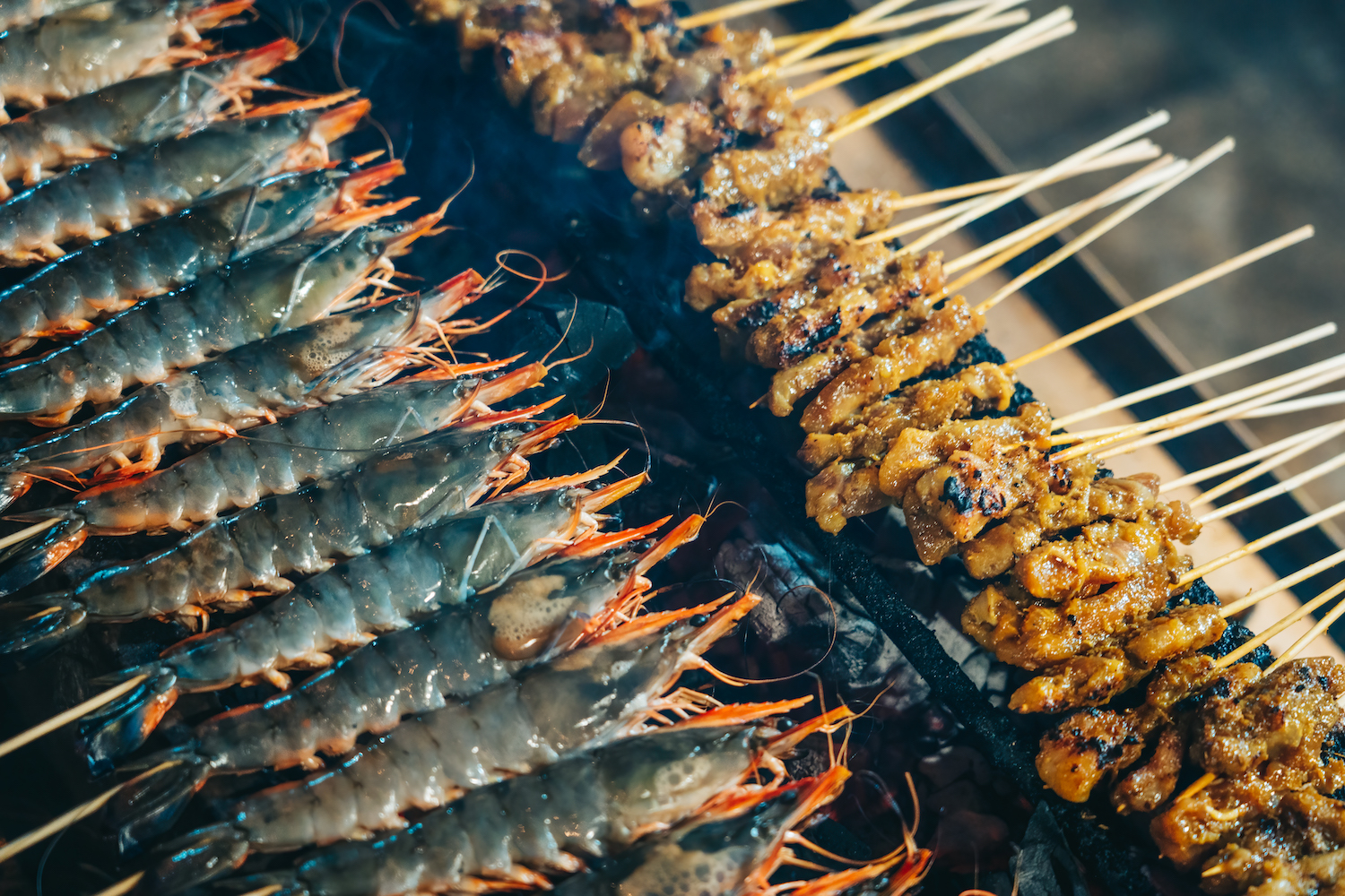 shrimp and chicken satay on a grill in singapore