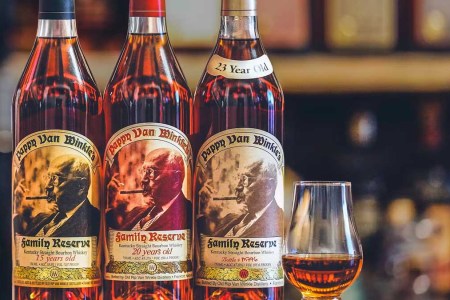 Three bottles of Pappy Van Winkle and a Glencairn glass. Huckberry is giving away three Pappy bottles.