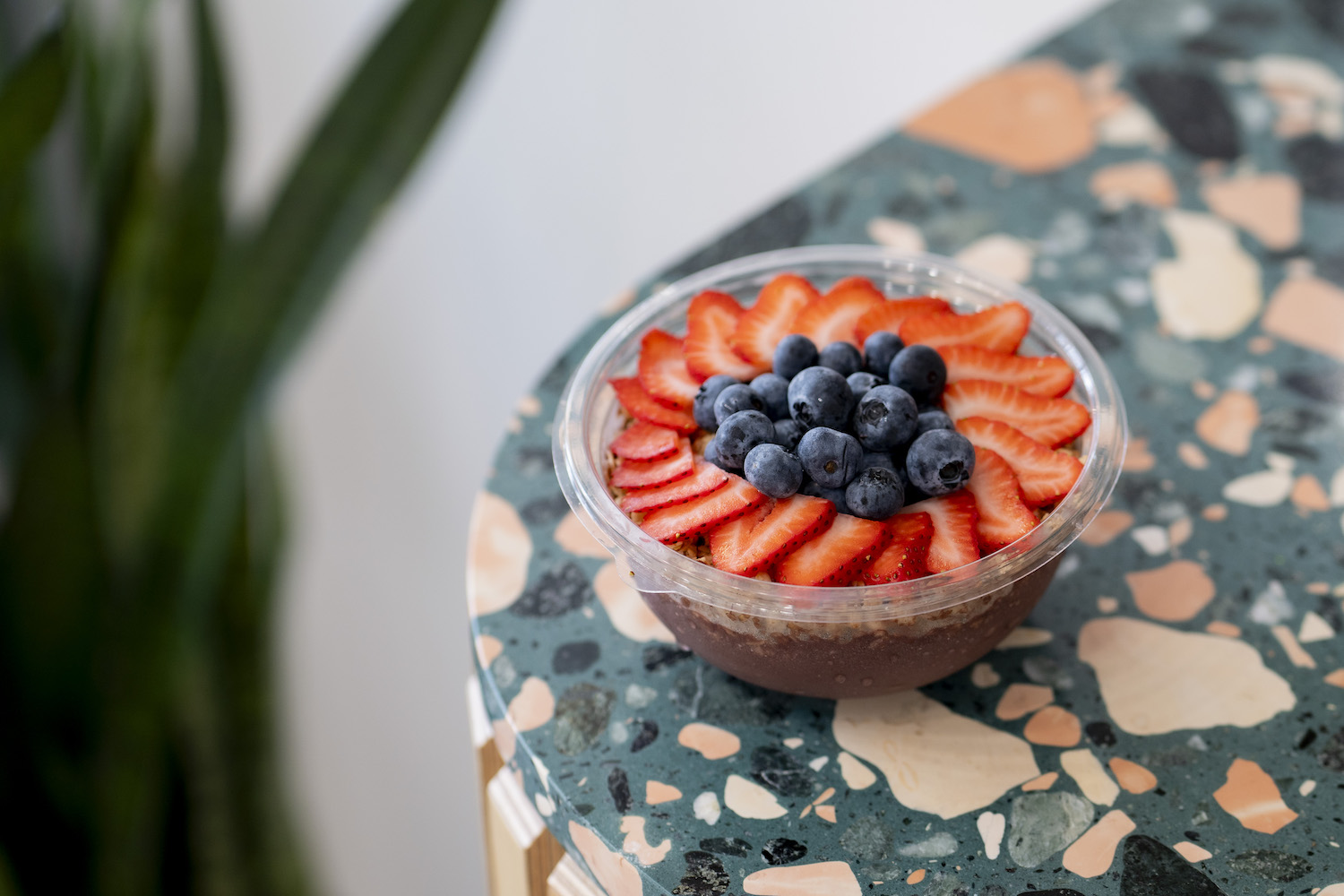 Acai bowl with strawberries and blueberries on a table