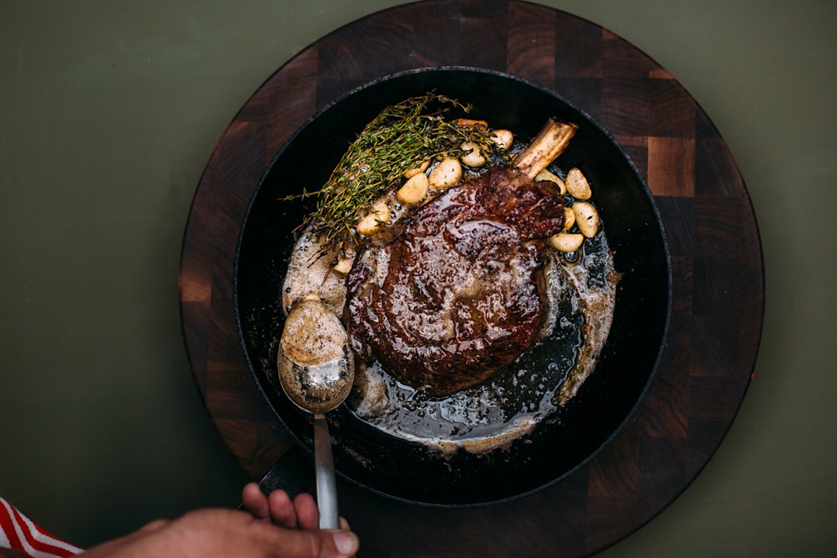 Steak in a cast iron pan with sauce