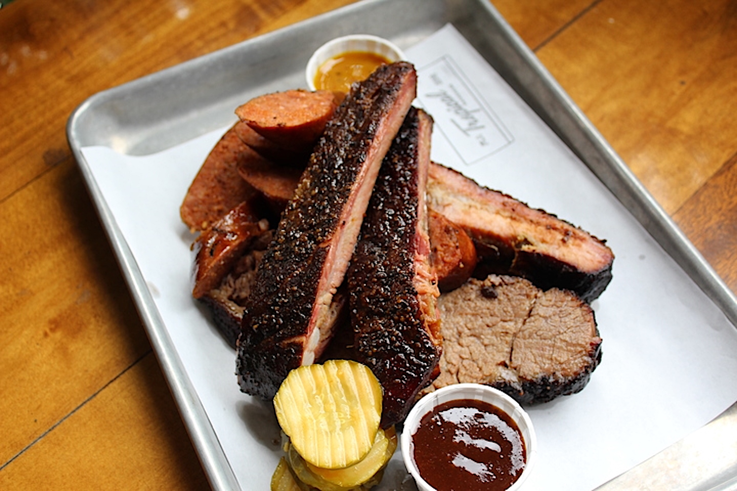 BBQ Meat on a tray with pickles and sauces miami's best new restaurants
