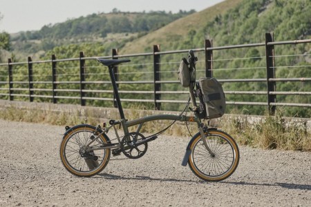 A picture of a folding bike in the outdoors.