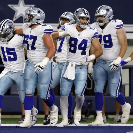 The Cowboys celebrate running a touchdown against the Raiders.