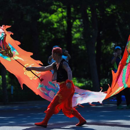 A Chinese man dancing with a dragon.