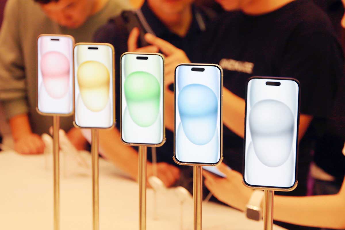 Customers experience the newly launched iPhone 15 series at Apple's flagship store in Shanghai, China, September 24, 2023