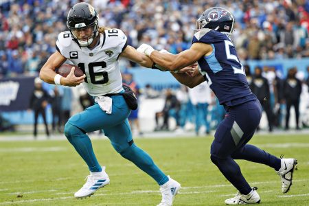 Trevor Lawrence of the Jaguars avoids a Tennessee Titan.