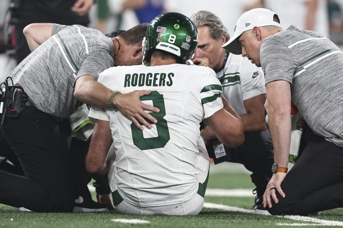 Aaron Rodgers being treated by the Jets medical staff.