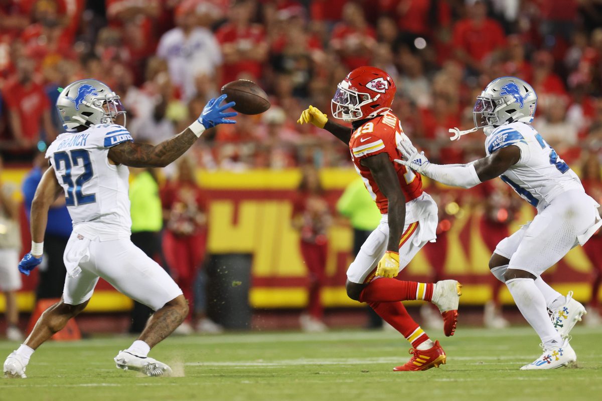 Brian Branch of the Lions intercepts a pass intended for Kadarius Toney.