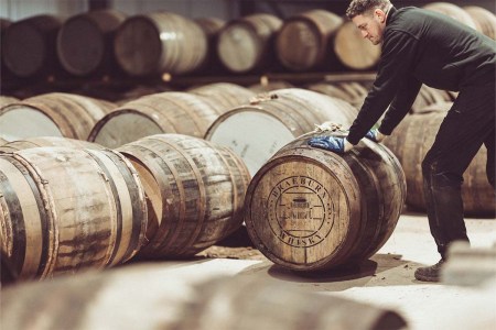 Barrels in a warehouse labeled Braeburn. The company allows investors to put their money into whisky casks.