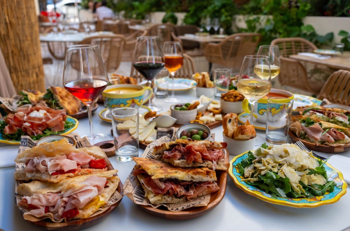 Spread of wine and sandwiches on a table from Sogno Toscano in Santa Monica