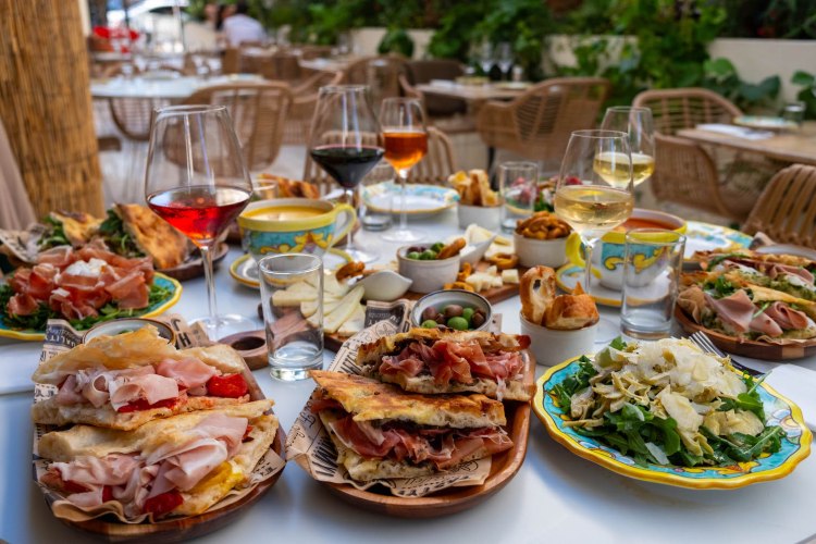 Spread of wine and sandwiches on a table from Sogno Toscano in Santa Monica