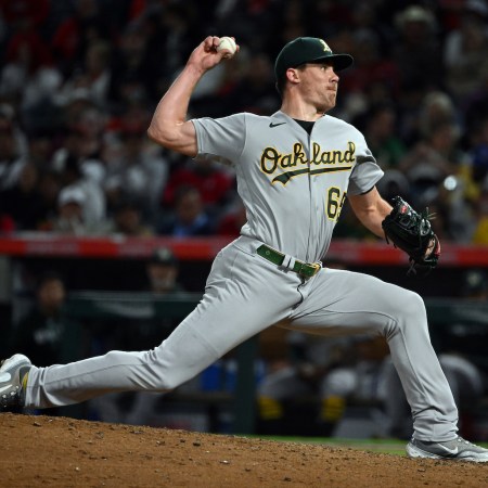 Oakland Athletics pitcher Trevor May (65) pitching during an MLB baseball game