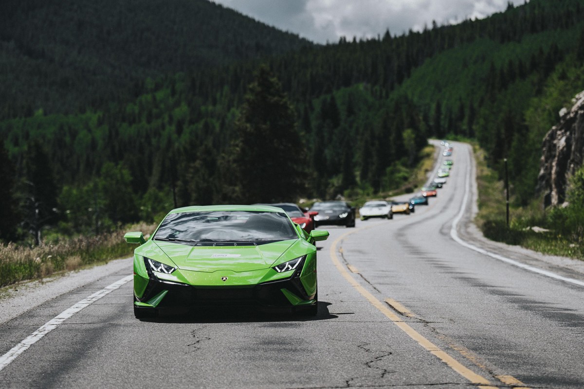 A line of Lamborghini supercars driving through rural roads in Aspen, led by the Lamborghini Huracán Tecnica