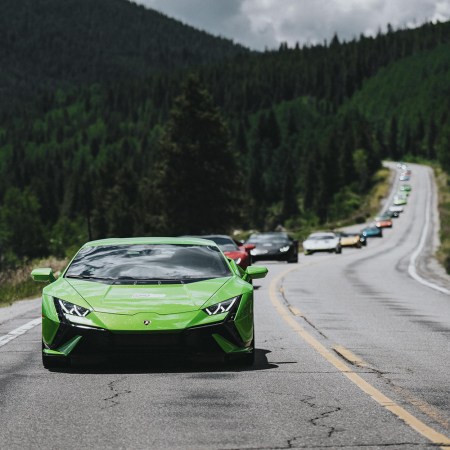 A line of Lamborghini supercars driving through rural roads in Aspen, led by the Lamborghini Huracán Tecnica