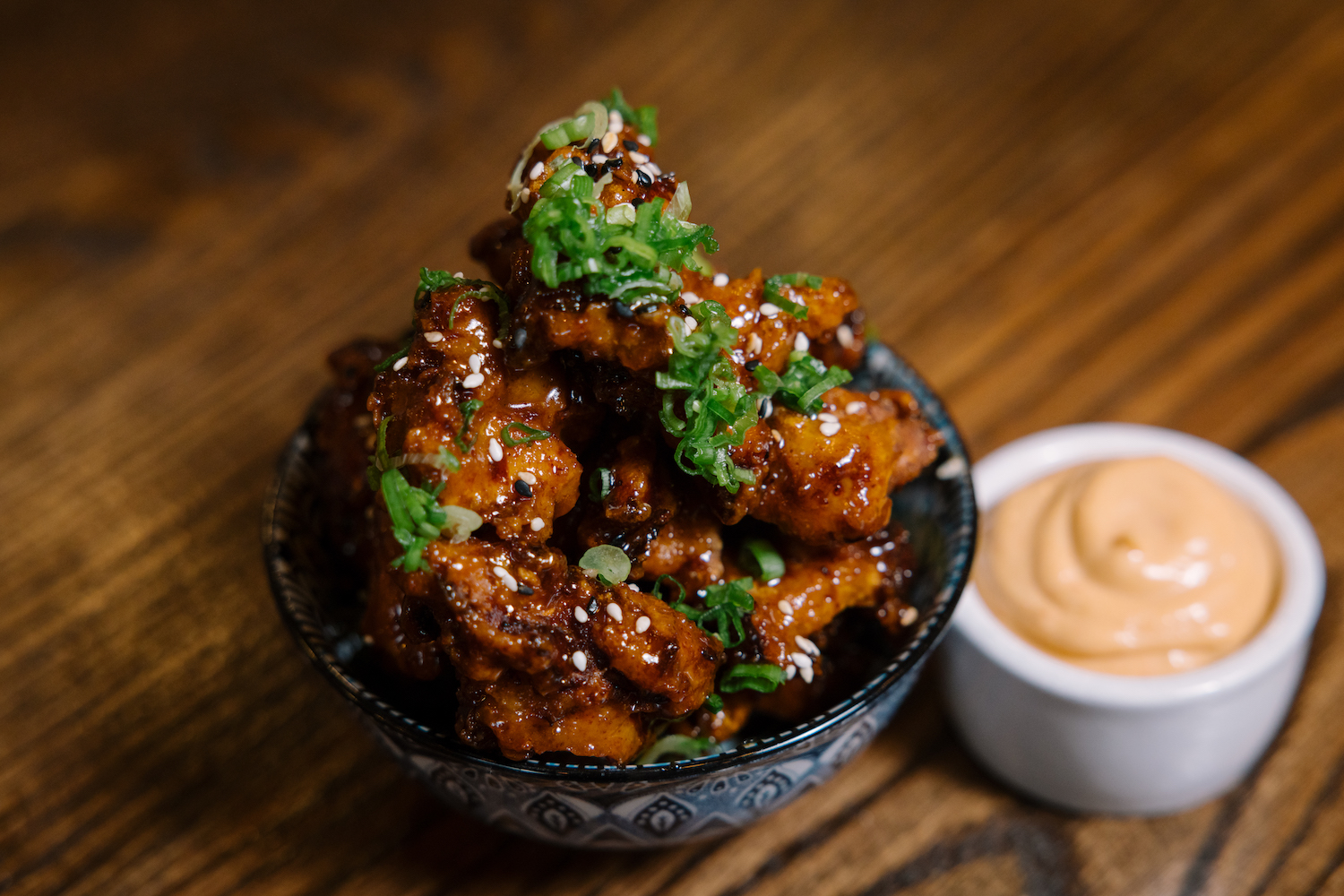 Crispy THC nuggets with spicy honey, toasted sesame and gochujang aioli dip