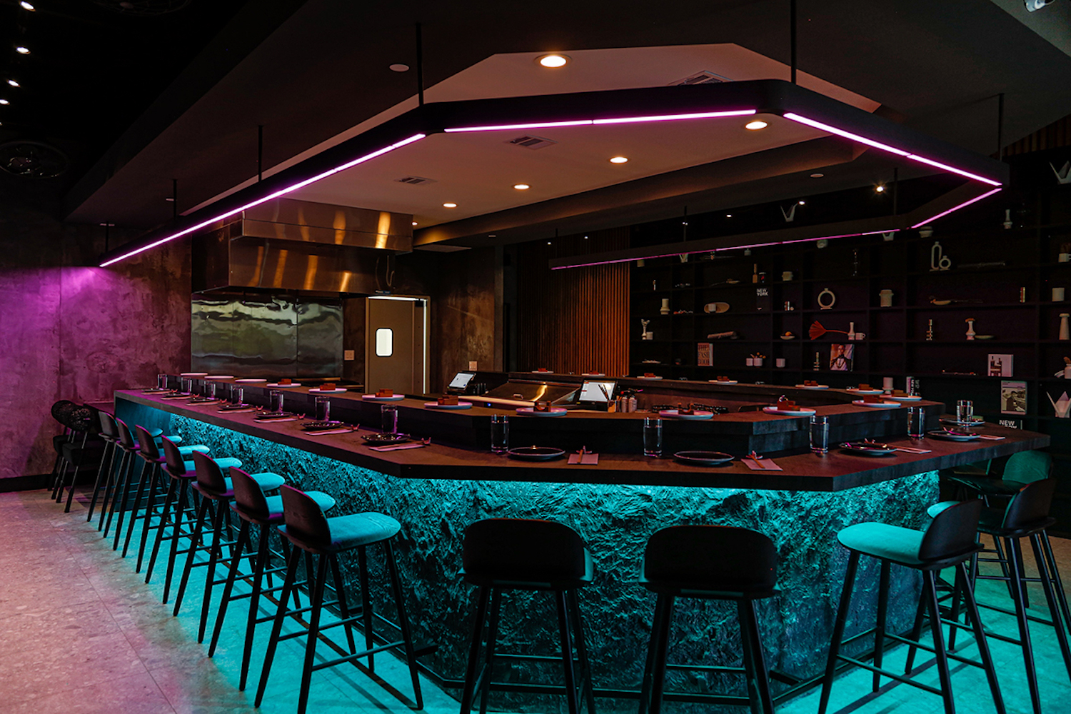 Dark bar area with neon purple and blue
