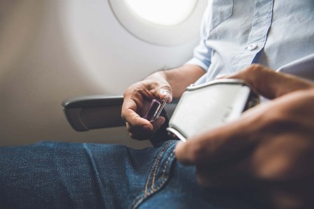 A person fastening a seatbelt on an airline. Some airlines claim Ozempic could lead to weight loss and save airlines millions.