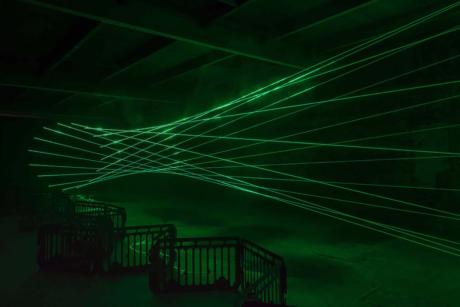Green lasers shooting across a room