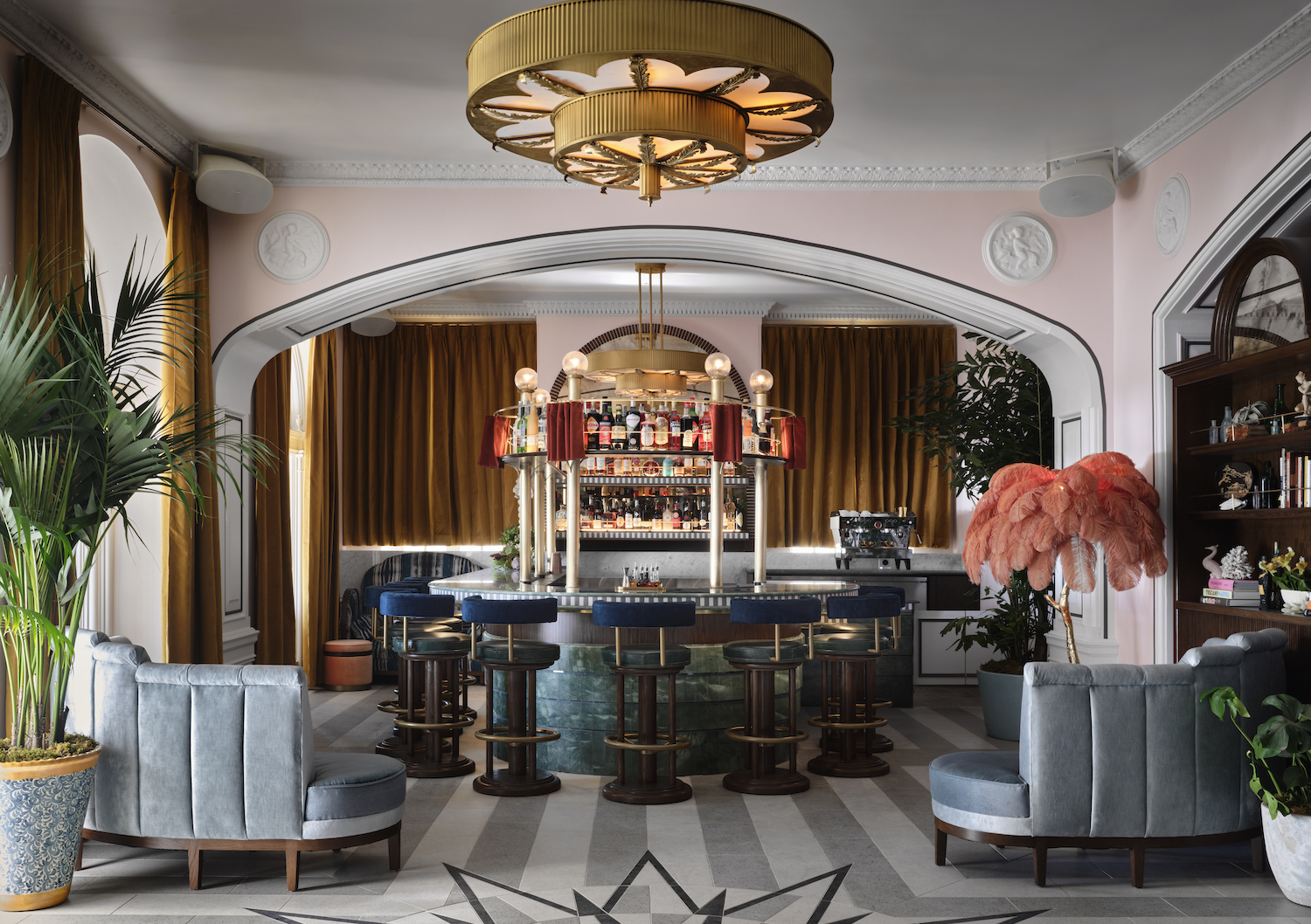 Horseshoe-shaped bar with chandelier and pink accents