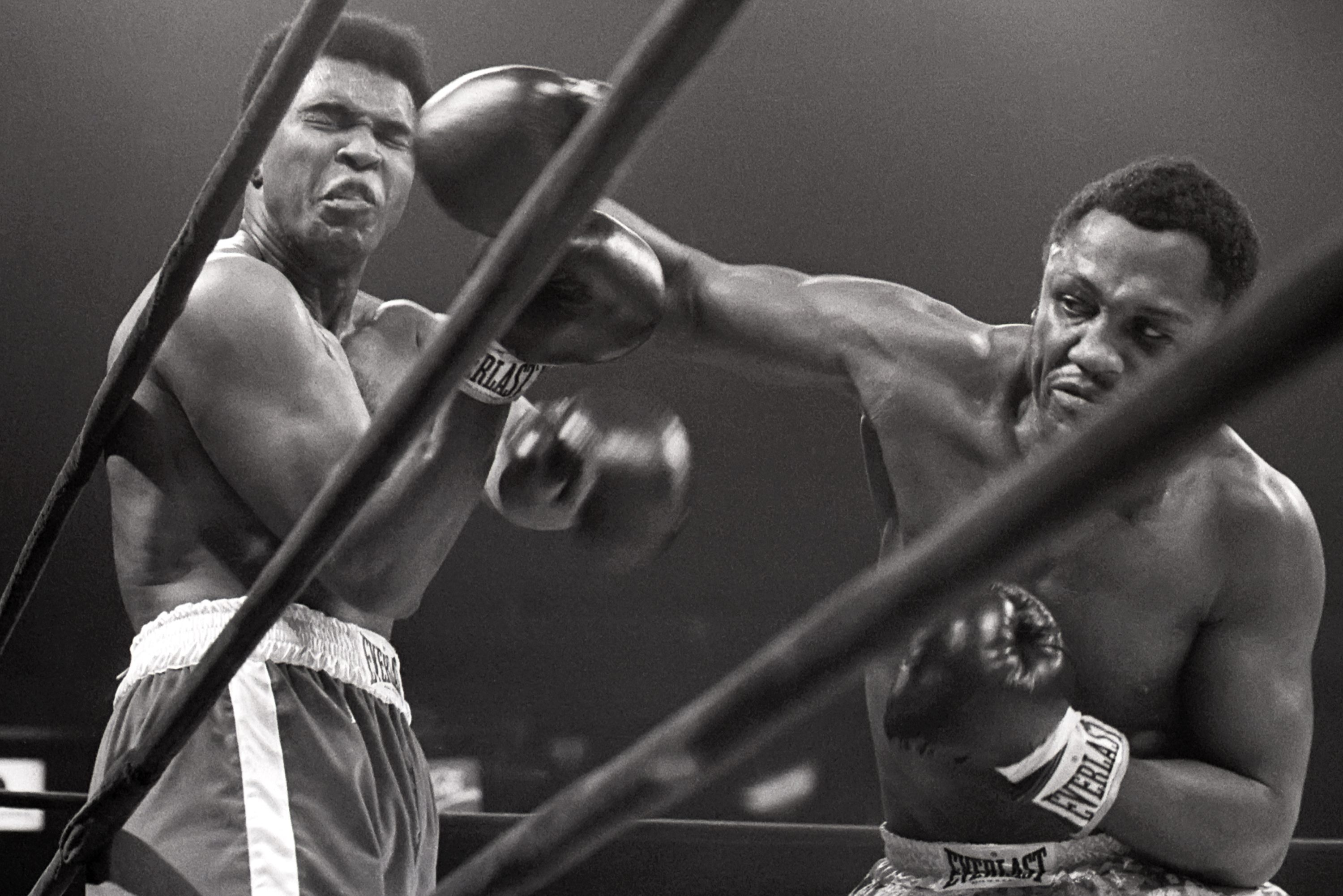 Muhammad Ali takes a hit from Joe Frazier.