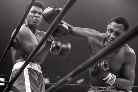 Muhammad Ali takes a hit from Joe Frazier.