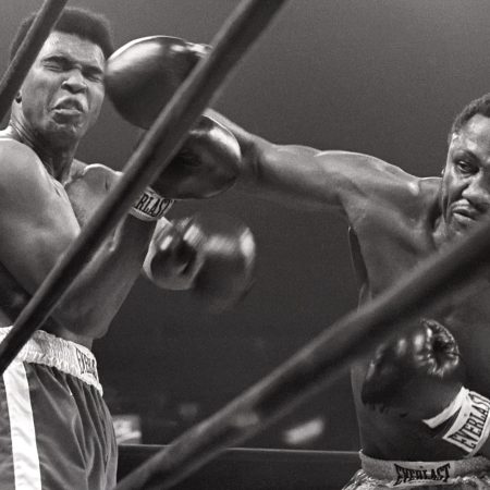 Muhammad Ali takes a hit from Joe Frazier.