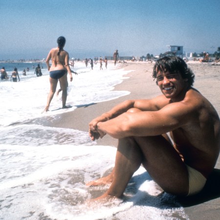 Arnold Schwarzenegger sitting on the beach, in his 20s, grinning. We look at the life lessons in his new book, "Be Useful"