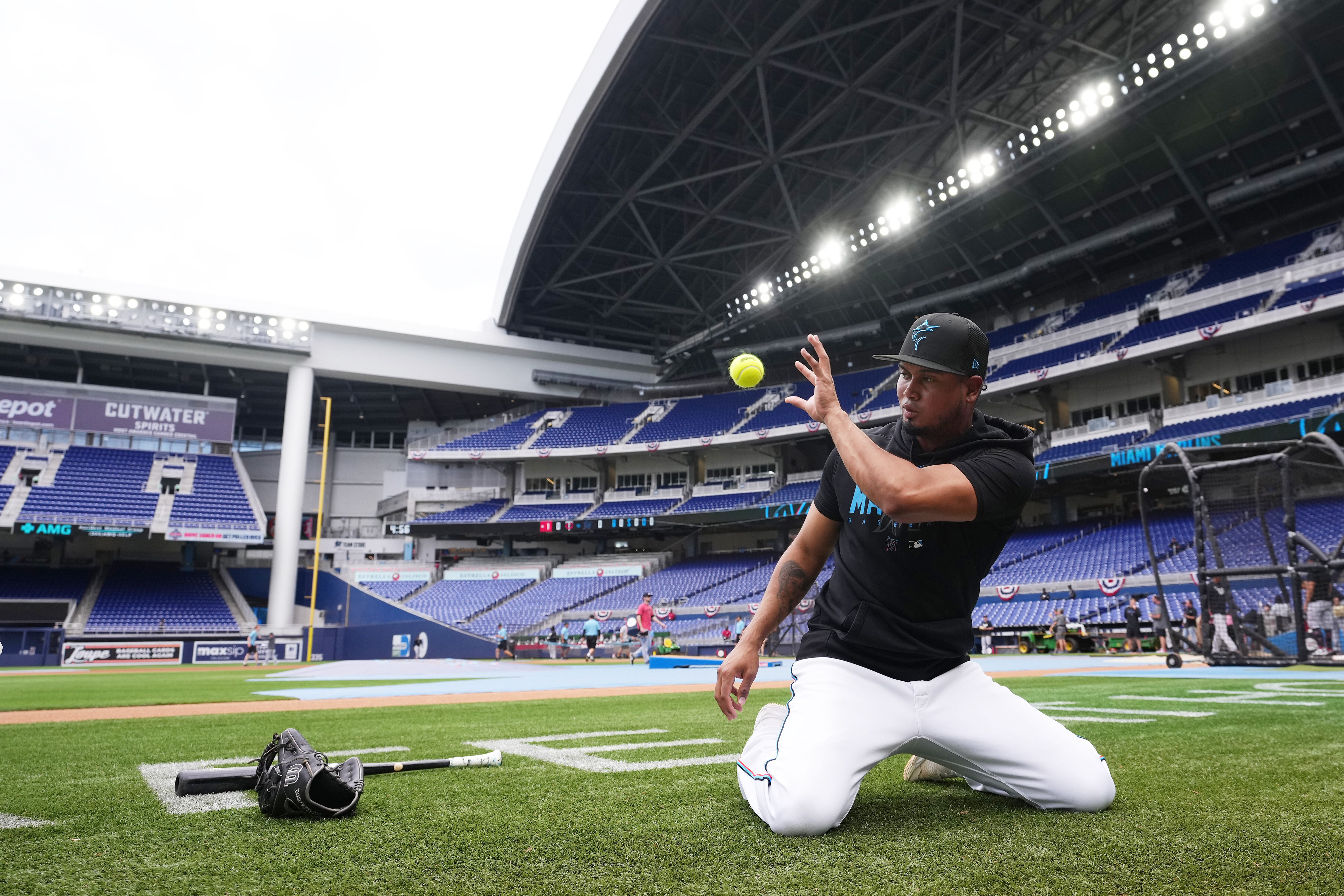 The baseball player Luis Arraez warms up before a game.