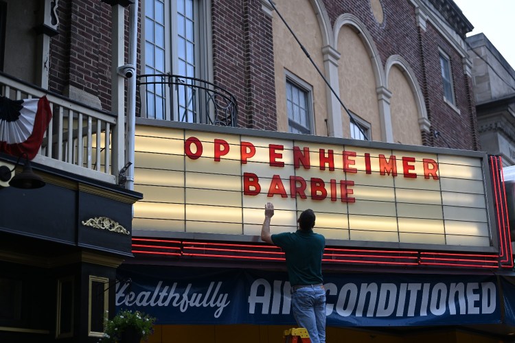 Movie theater marquee with "Barbie" and "Oppenheimer"