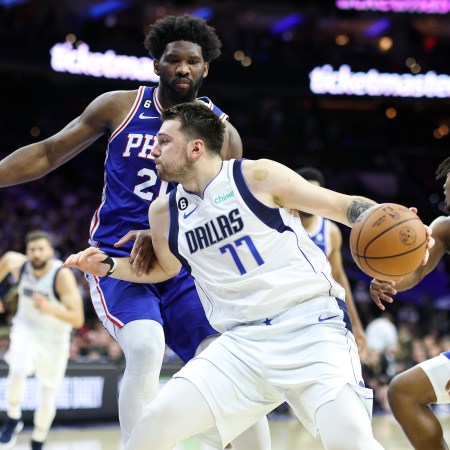 Luka Doncic drives against Joel Embiid, preparing for his signature step-back.