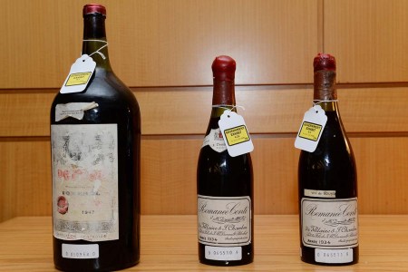 Three bottles of wine used as evidence in the trial of wine dealer Rudy Kurniawan are displayed in Federal Court on December 19, 2013 in New York. Kurniawan was found guilty of masterminding a lucrative scheme to sell fake vintage wine in New York and London. He's now out and hosting dinner parties serving his fake wine.