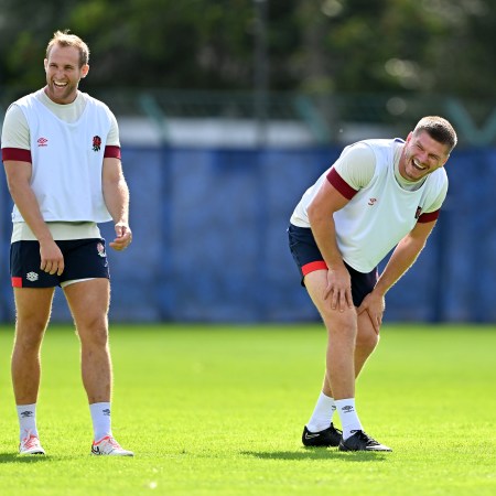Two rugby players laughing during practice.
