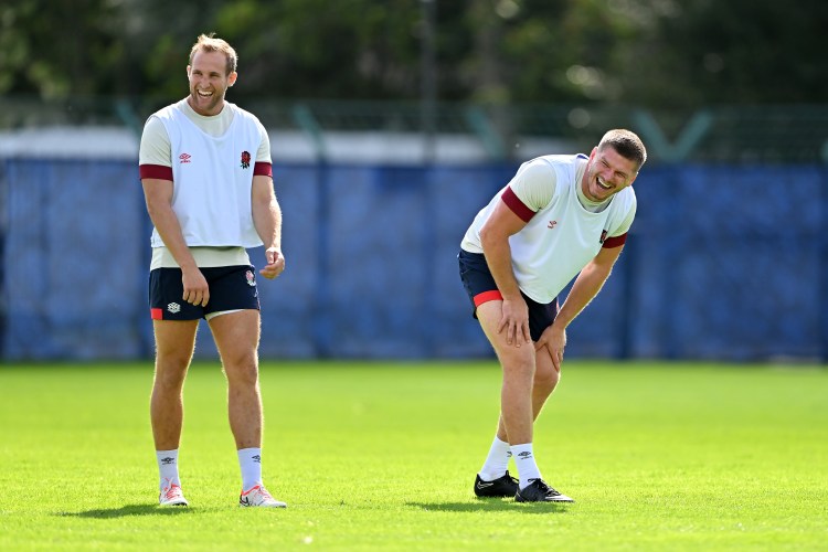 Two rugby players laughing during practice.