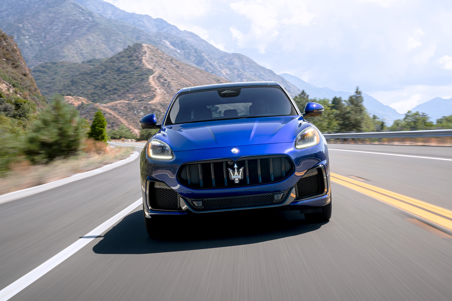 2023 Maserati Grecale Trofeo crossover in blue driving down the road