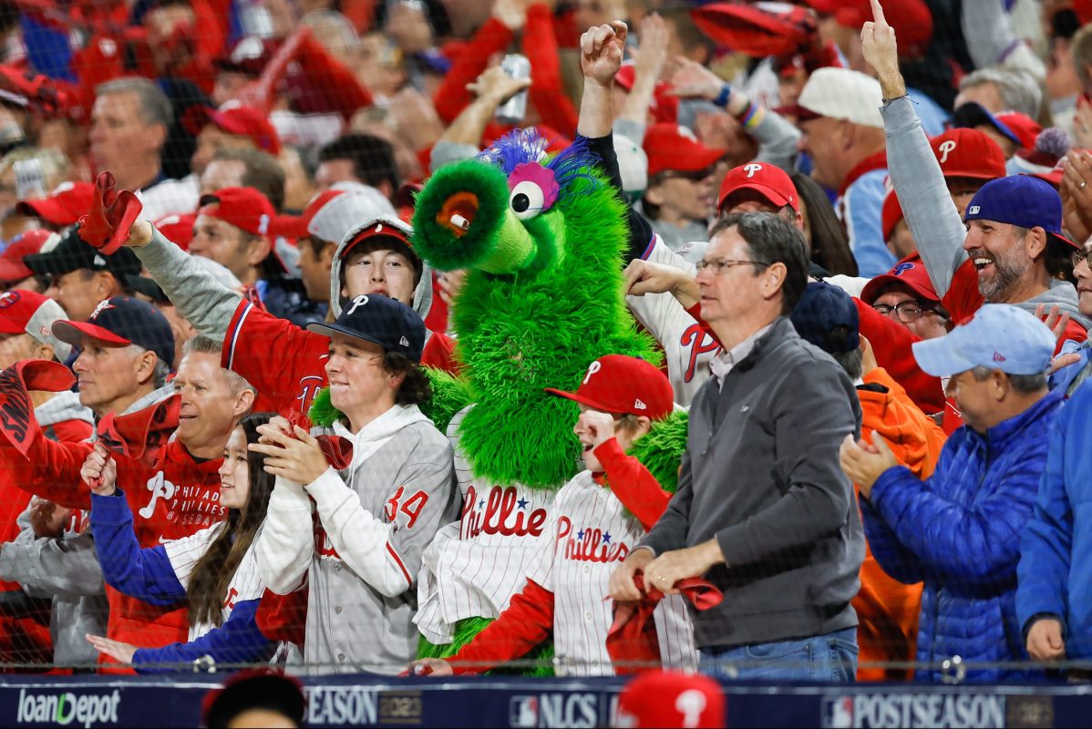 The Phanatic cheers with Phillies fans in the stands.
