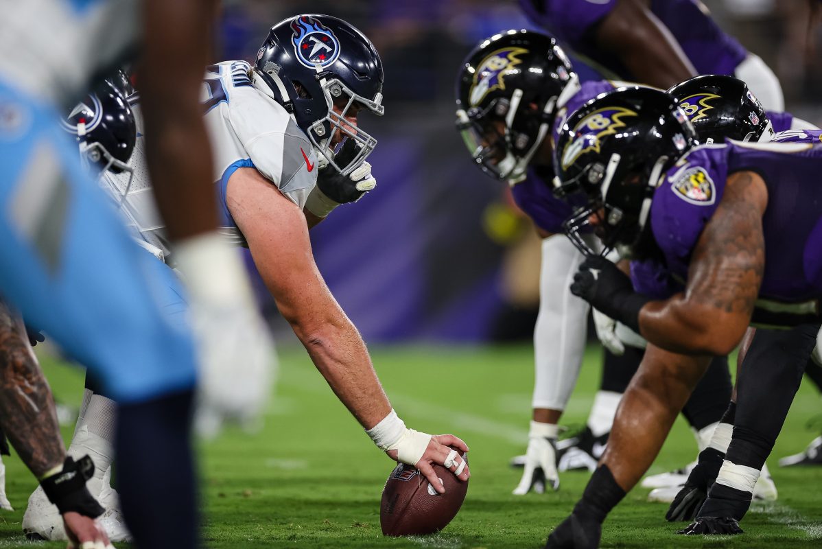 Corey Levin of the Titans prepares to snap the ball against the Ravens.