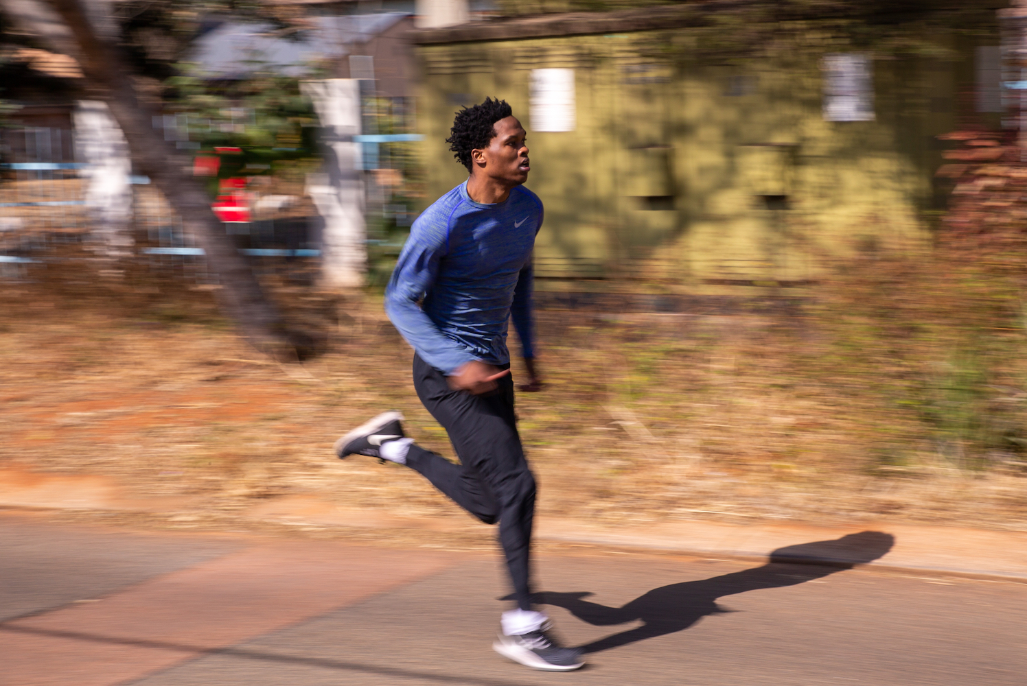 A man sprints down the street.