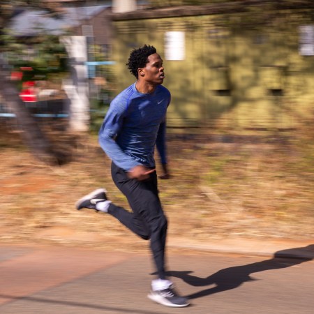 A man sprints down the street.