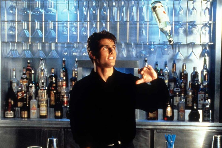 Tom Cruise showing his tricks as a bartender in a scene from the film 'Cocktail', 1988.