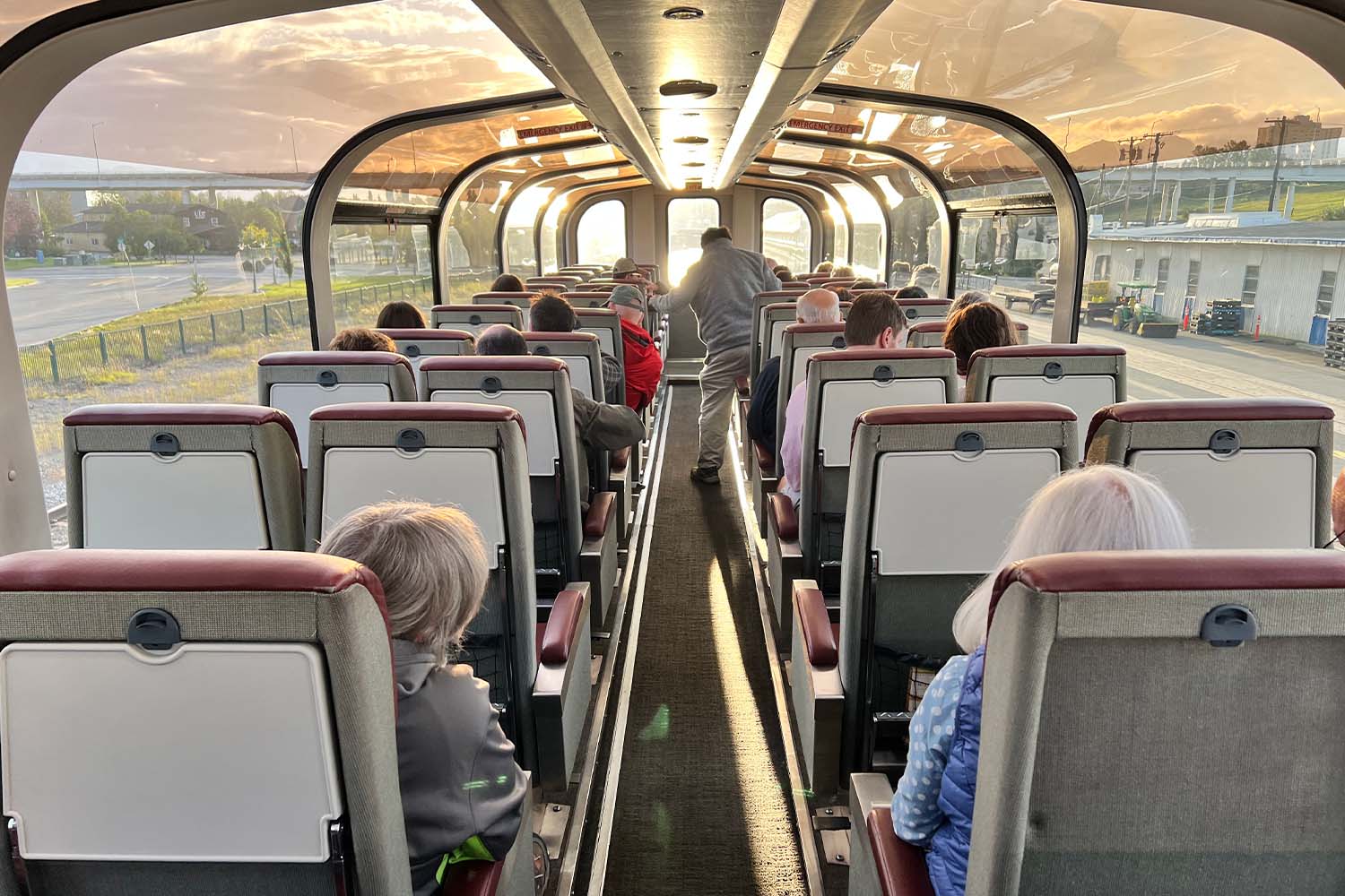 The railcars feature large curved glass windows that run the full length of the car, allowing 360 degree viewing