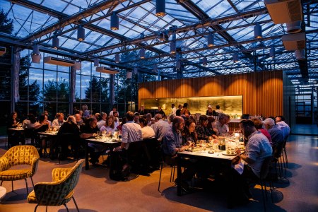 People sitting at tables inside Granor Farm