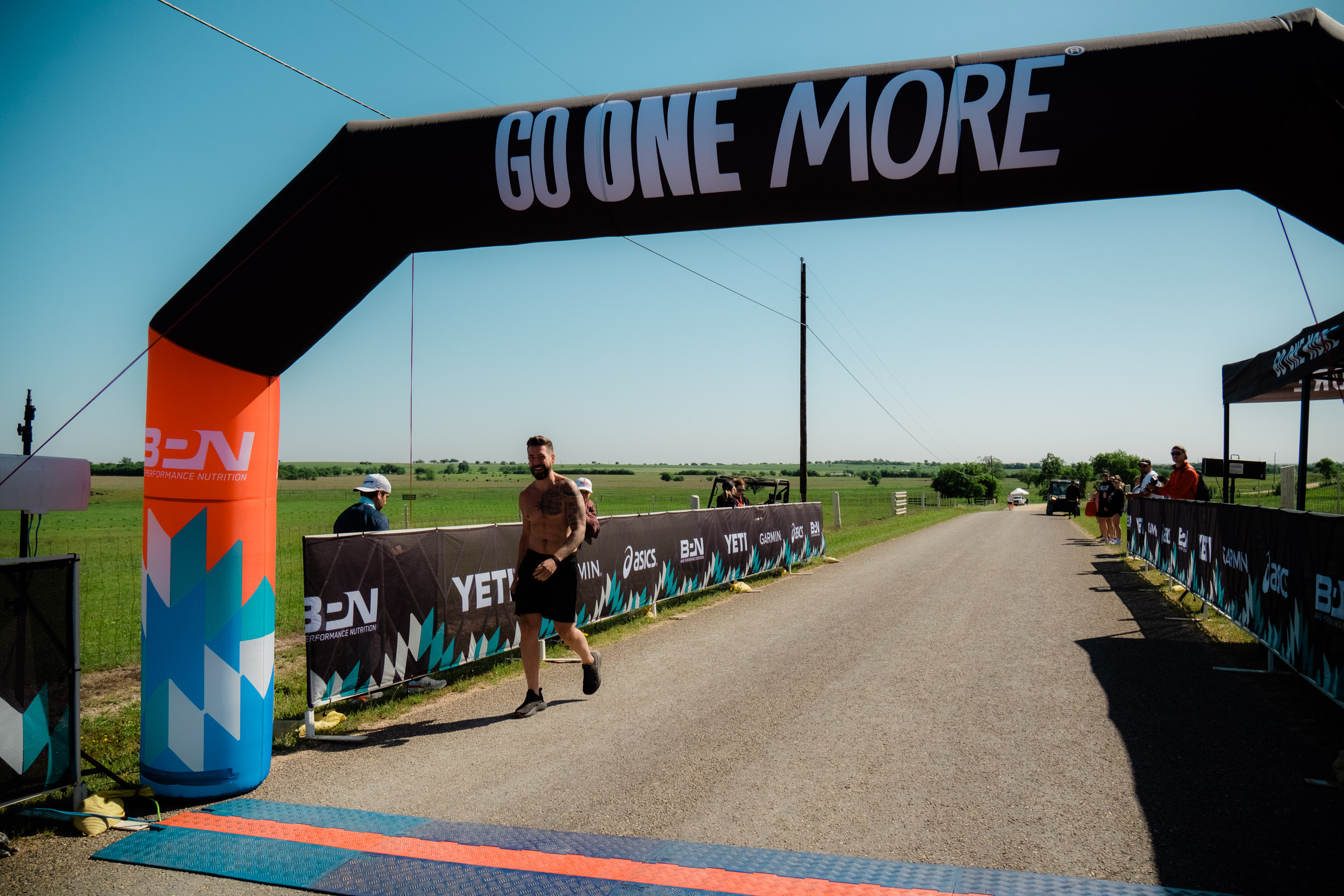 Author Charles Thorp crossing the finish line at the Go One More Marathon.