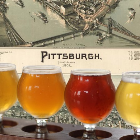 A map of Pittsburgh, Pennsylvania behind a lineup of local beers. Here are the 11 best breweries in the city.