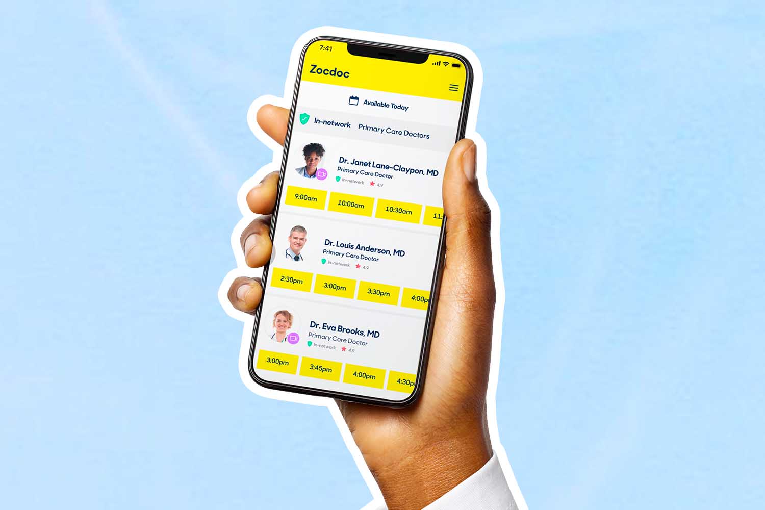 A hand holding a phone with the Zocdoc app open