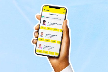 A hand holding a phone with the Zocdoc app open