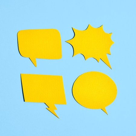 Four yellow comic book voice bubbles against a light blue background.