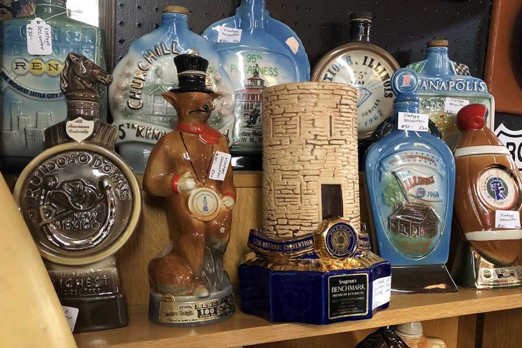 A shelf of vintage bourbon decanters