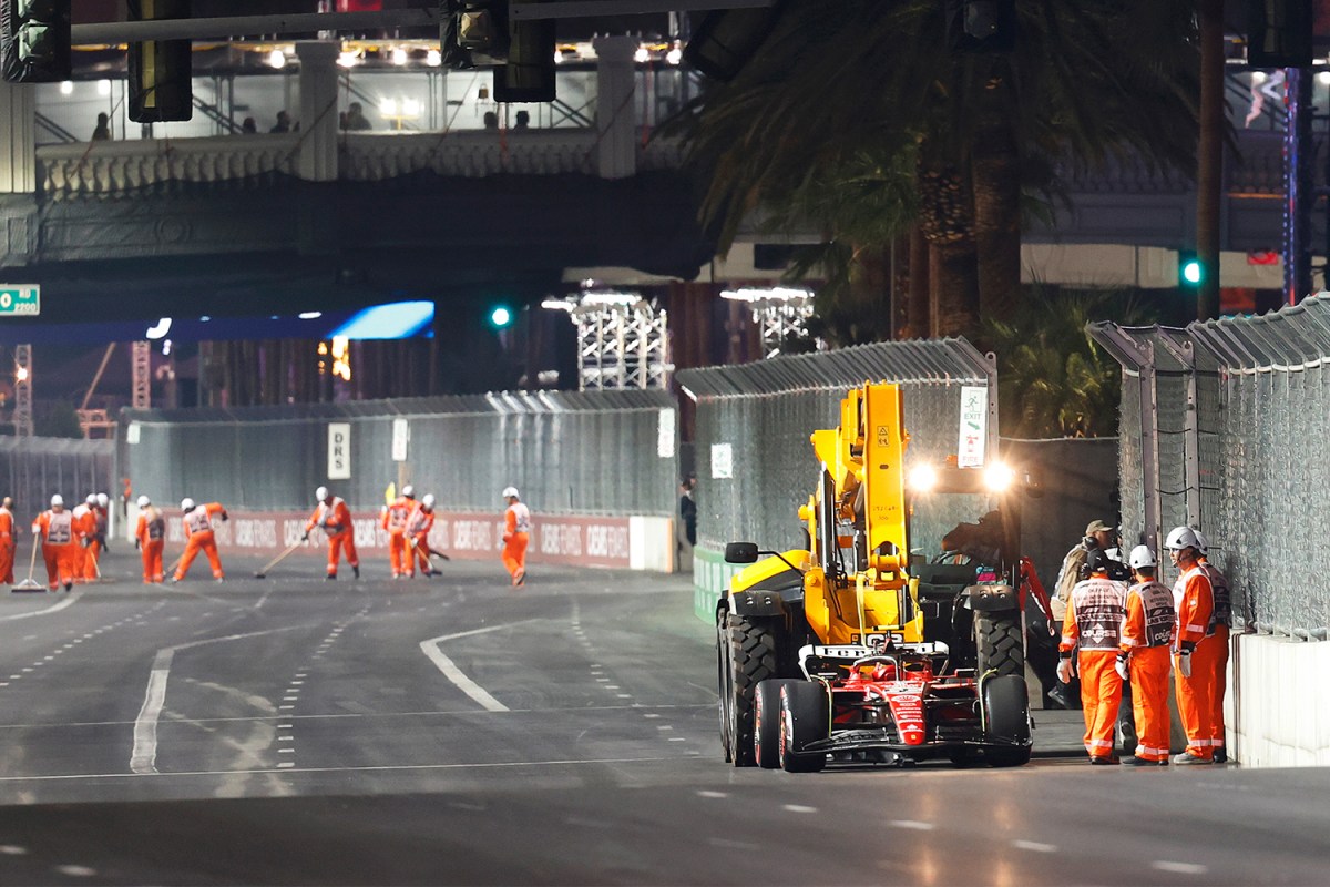 Ferrari's Carlos Sainz leaves his car on the track in Las Vegas after a loose drain cover damaged his car during the first practice session at the F1 Las Vegas Grand Prix