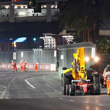 Ferrari's Carlos Sainz leaves his car on the track in Las Vegas after a loose drain cover damaged his car during the first practice session at the F1 Las Vegas Grand Prix